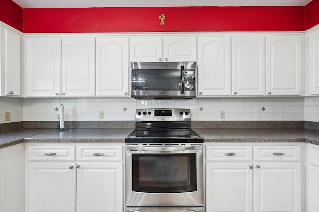 kitchen with white cabinets, backsplash, and appliances with stainless steel finishes