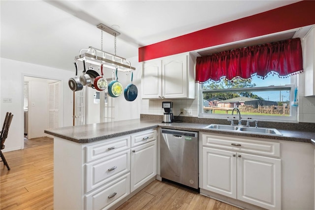 kitchen featuring dishwasher, light wood-type flooring, decorative backsplash, and white cabinetry