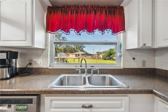 kitchen featuring white cabinetry, decorative backsplash, a wealth of natural light, and sink