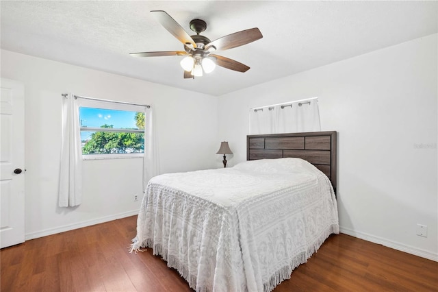 bedroom featuring ceiling fan and dark hardwood / wood-style floors