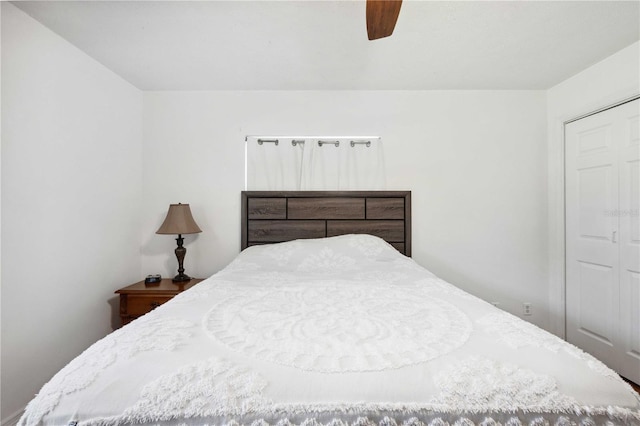 bedroom with ceiling fan and a closet