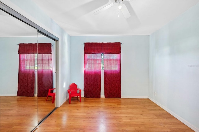 entryway featuring a wealth of natural light, hardwood / wood-style flooring, and ceiling fan