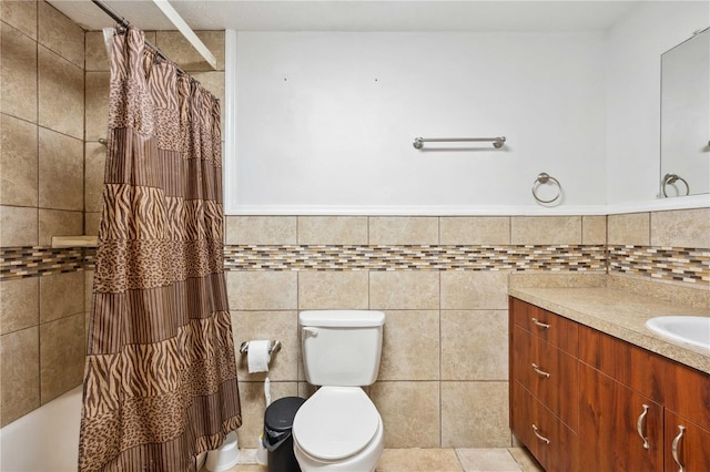 full bathroom with tile walls, vanity, tile patterned floors, and toilet