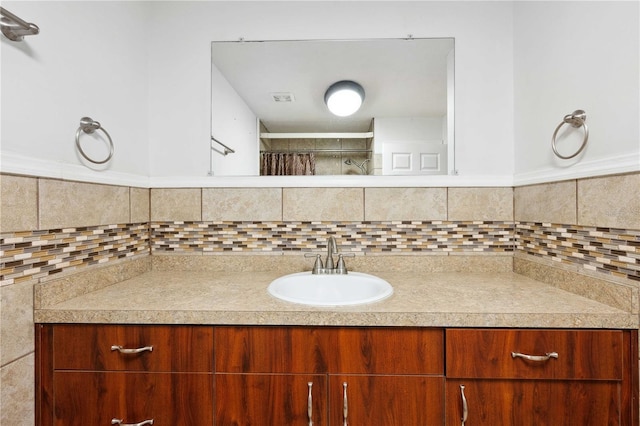 bathroom with vanity and tasteful backsplash