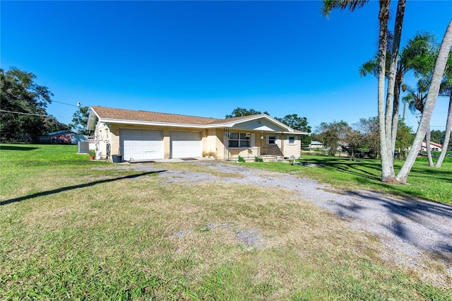 ranch-style house with a garage and a front lawn