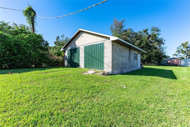 view of outbuilding featuring a lawn