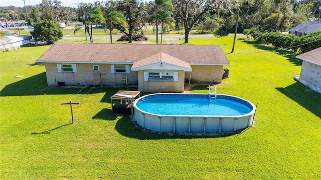 view of swimming pool with a yard