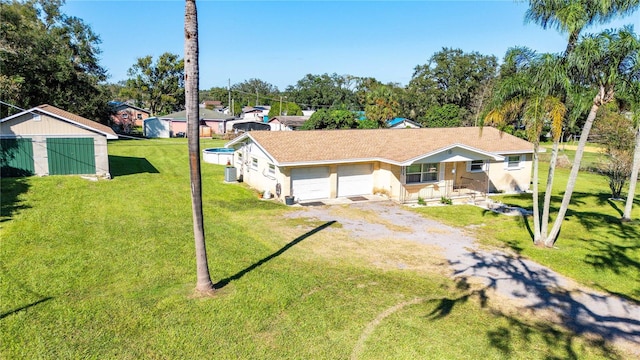 view of front of property with a front lawn and a garage