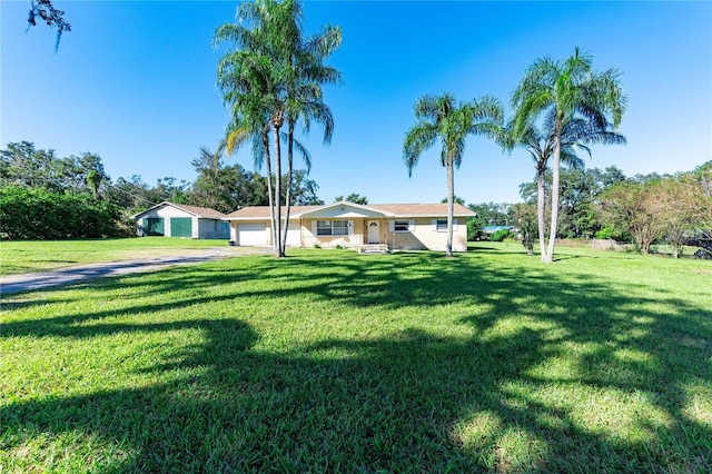 single story home featuring a garage and a front yard