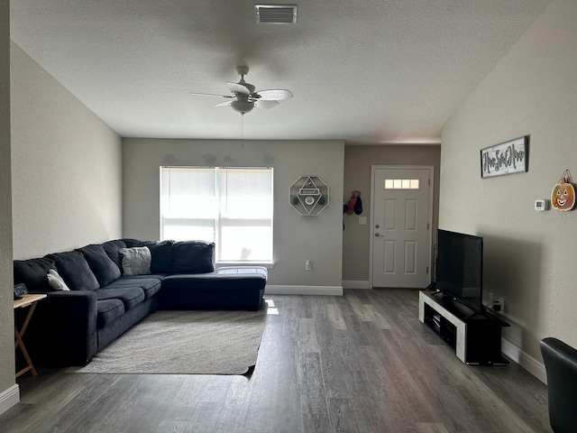 1541 W G Martinelli Blvd, Citrus Springs, FL 34434 - living room featuring a ceiling fan, a textured ceiling, visible vents, wood finished floors, and baseboards