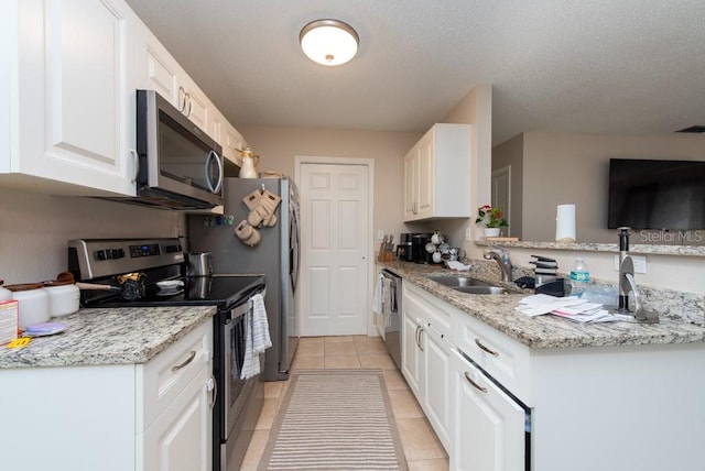 kitchen featuring sink, a textured ceiling, kitchen peninsula, white cabinetry, and stainless steel appliances