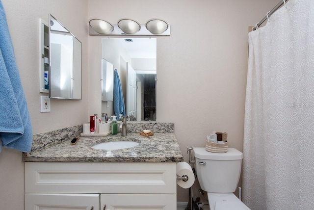 bathroom featuring vanity and toilet