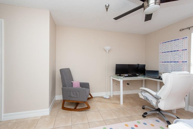 tiled office space featuring a textured ceiling and ceiling fan