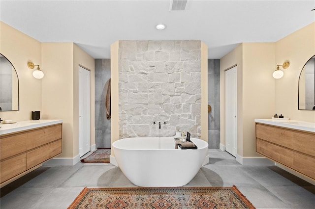 bathroom with vanity, concrete floors, and shower with separate bathtub