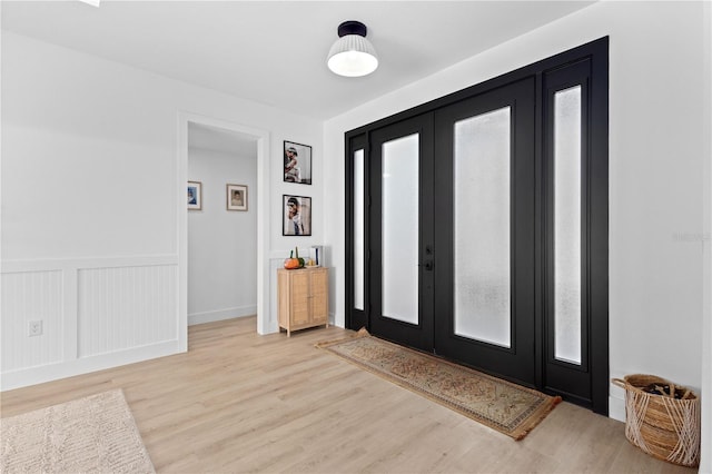 entryway featuring french doors and light hardwood / wood-style flooring