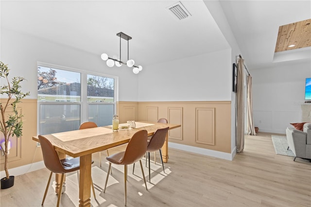 dining room with an inviting chandelier and light wood-type flooring