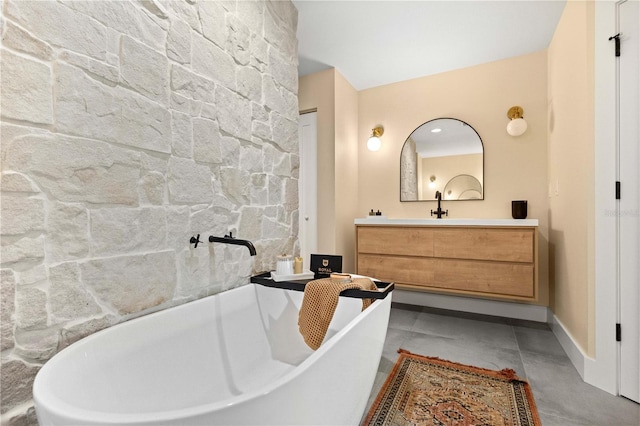 bathroom with vanity and a tub