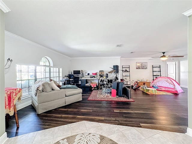 living room featuring ceiling fan, crown molding, and hardwood / wood-style floors