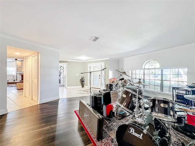 interior space with ornamental molding, hardwood / wood-style floors, and ceiling fan