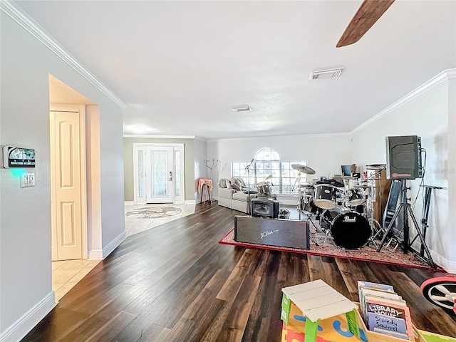 living room with crown molding, hardwood / wood-style floors, and ceiling fan