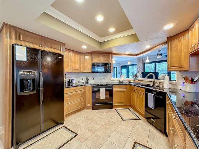 kitchen featuring black appliances, sink, dark stone countertops, crown molding, and decorative backsplash