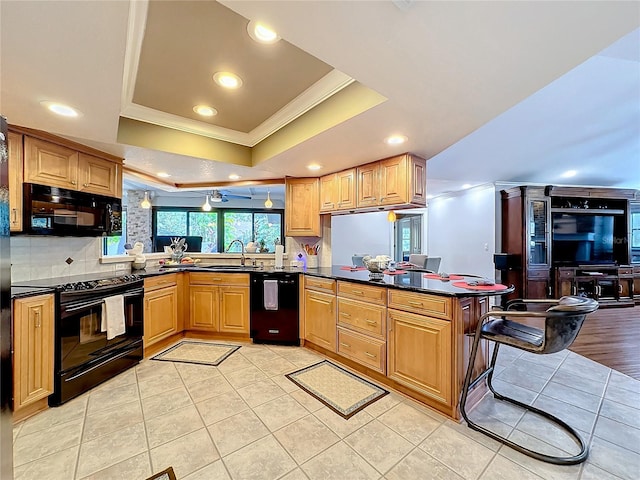 kitchen with kitchen peninsula, decorative backsplash, ornamental molding, black appliances, and sink