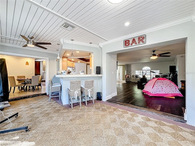 kitchen featuring crown molding, hardwood / wood-style flooring, wooden ceiling, and ceiling fan