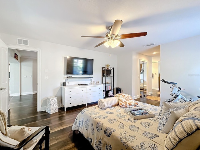 bedroom with dark wood-type flooring, ceiling fan, and a closet