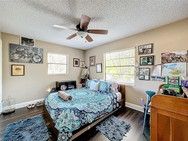 bedroom featuring a textured ceiling, dark wood-type flooring, and ceiling fan