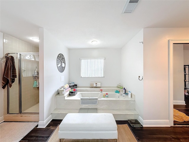 bathroom with hardwood / wood-style flooring and plus walk in shower