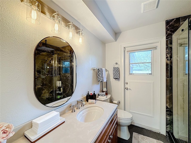 bathroom with vanity, toilet, and walk in shower