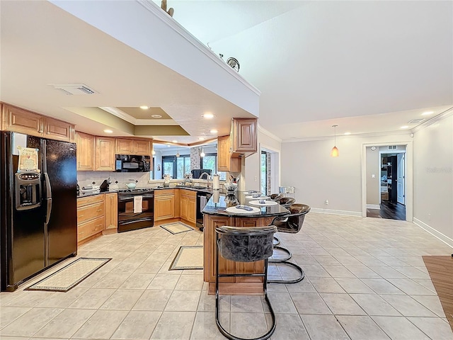 kitchen with light tile patterned flooring, a breakfast bar, a raised ceiling, kitchen peninsula, and black appliances