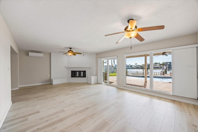 7886 9th Ave S, Saint Petersburg, FL 33707 - unfurnished living room with an AC wall unit, a ceiling fan, a water view, and light wood-type flooring