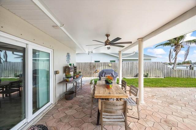 7886 9th Ave S, Saint Petersburg, FL 33707 - fenced backyard featuring a patio area, a ceiling fan, outdoor dining area, and a grill
