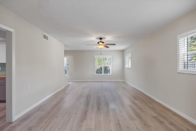 7886 9th Ave S, Saint Petersburg, FL 33707 - empty room featuring light wood finished floors, a ceiling fan, and healthy amount of natural light
