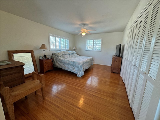7886 9th Ave S, Saint Petersburg, FL 33707 - bedroom featuring light wood-style flooring, a closet, and a ceiling fan