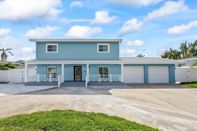 7886 9th Ave S, Saint Petersburg, FL 33707 - view of front of house with a porch, an attached garage, a gate, and concrete driveway