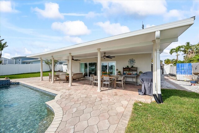 7886 9th Ave S, Saint Petersburg, FL 33707 - rear view of house featuring ceiling fan, a fenced backyard, a patio, and outdoor dining area