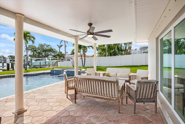 7886 9th Ave S, Saint Petersburg, FL 33707 - fenced backyard featuring a ceiling fan, an outdoor pool, a patio area, outdoor lounge area, and an outdoor hot tub