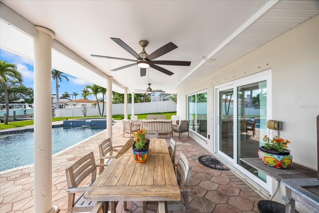 7886 9th Ave S, Saint Petersburg, FL 33707 - fenced backyard featuring a patio, outdoor dining area, and ceiling fan