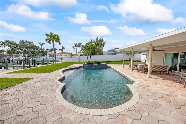 7886 9th Ave S, Saint Petersburg, FL 33707 - view of pool with a patio, a ceiling fan, a fenced backyard, boat lift, and a dock