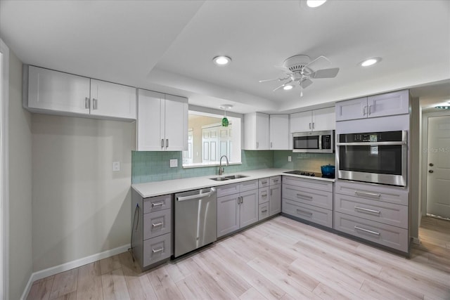 7886 9th Ave S, Saint Petersburg, FL 33707 - kitchen with appliances with stainless steel finishes, a sink, gray cabinets, baseboards, and recessed lighting
