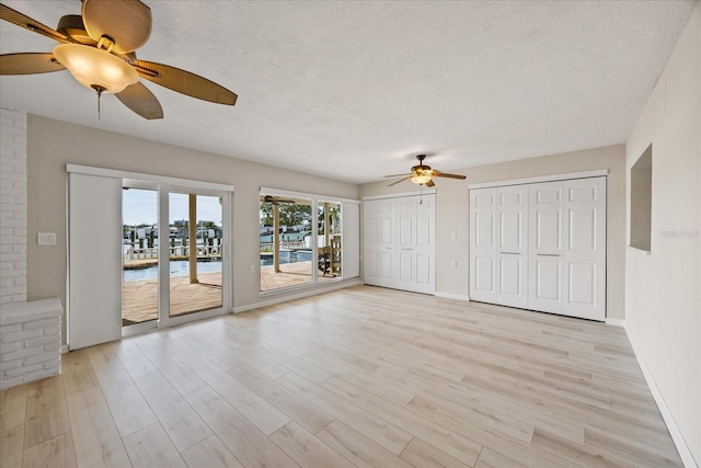 7886 9th Ave S, Saint Petersburg, FL 33707 - unfurnished living room featuring ceiling fan, light wood-style flooring, and baseboards