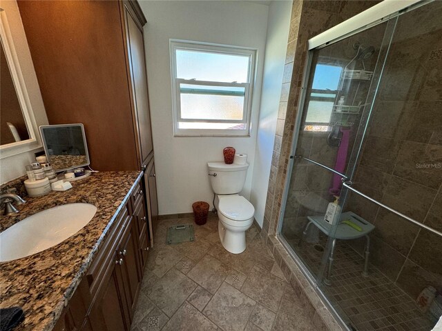 7886 9th Ave S, Saint Petersburg, FL 33707 - bathroom with vanity, a shower stall, healthy amount of natural light, and toilet
