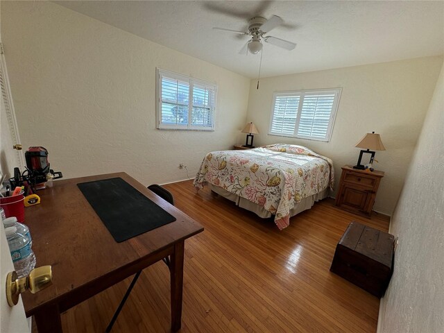 7886 9th Ave S, Saint Petersburg, FL 33707 - bedroom with a textured wall, light wood-type flooring, and a ceiling fan