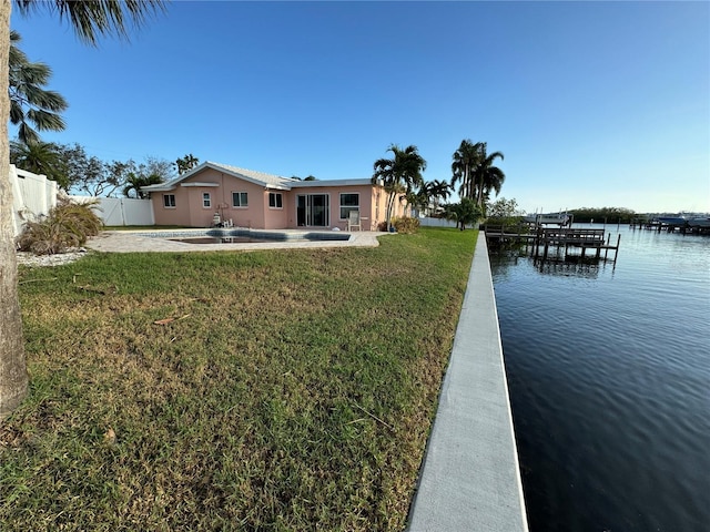 exterior space with a lawn, a water view, and a patio area