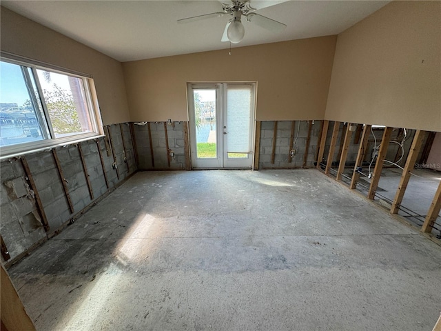 spare room featuring a healthy amount of sunlight and ceiling fan