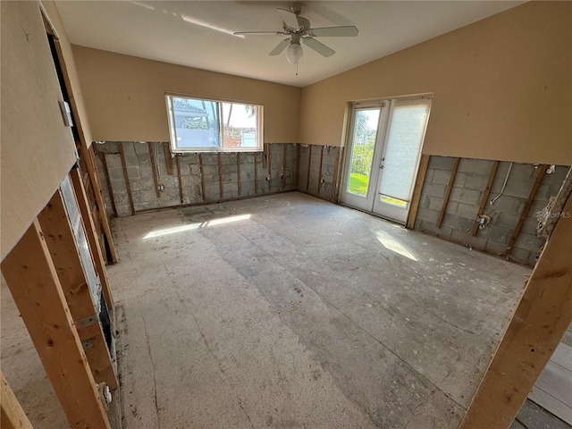 spare room with plenty of natural light, ceiling fan, and vaulted ceiling