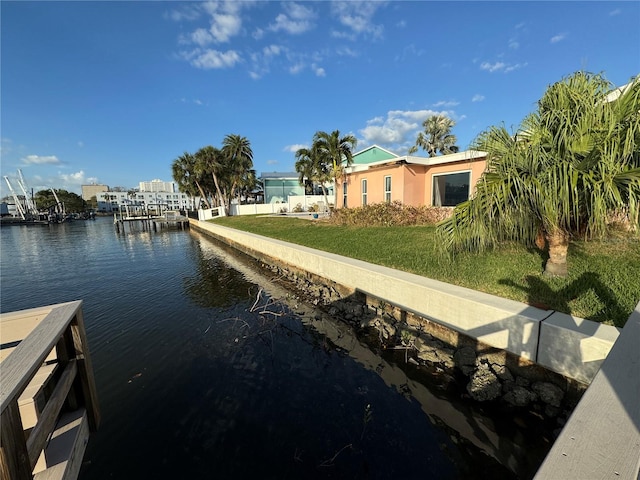 dock area featuring a water view and a yard