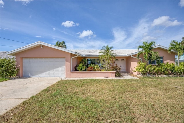 ranch-style home with a garage and a front lawn